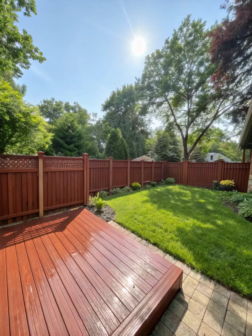 A beautifully landscaped backyard with a newly built deck, showcasing Elex Construction's landscaping and deck services.